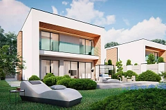 Современный двухэтажный дом с большим остеклением из сада и балконом на втором этаже.